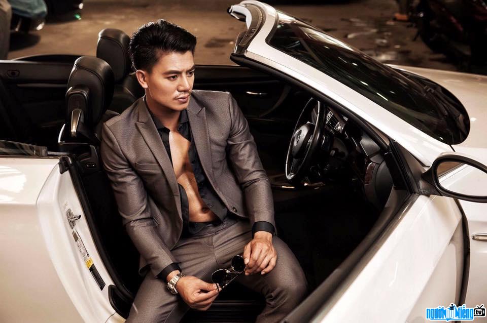  Image of actor Hieu Nguyen showing off his "men" body on the side of a supercar
