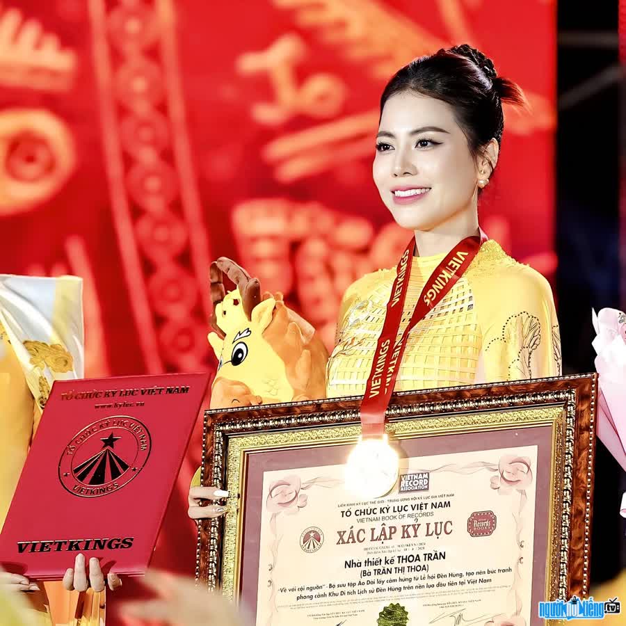 Image of designer Thoa Tran receiving prestigious awards