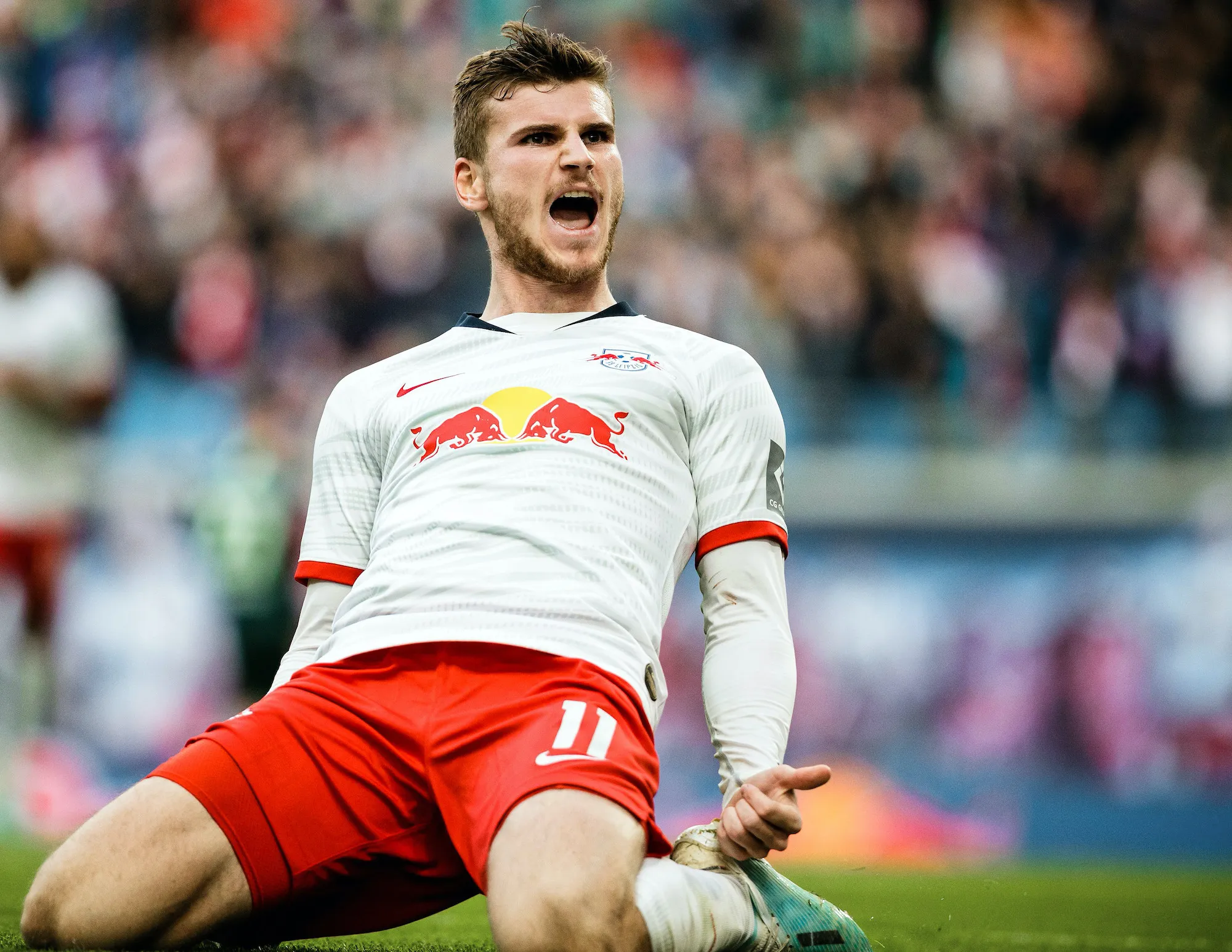 Image of player Timo Werner celebrating victory on the field