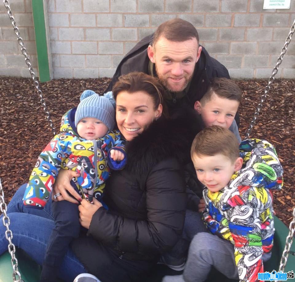 Picture of football player Wayne Rooney with his wife and sons