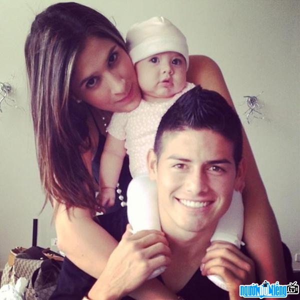 A photo of James Rodriguez playing happily with his wife and daughter