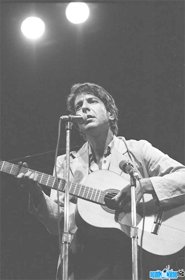 A photo of singer Leonard Cohen performing on stage in 1967