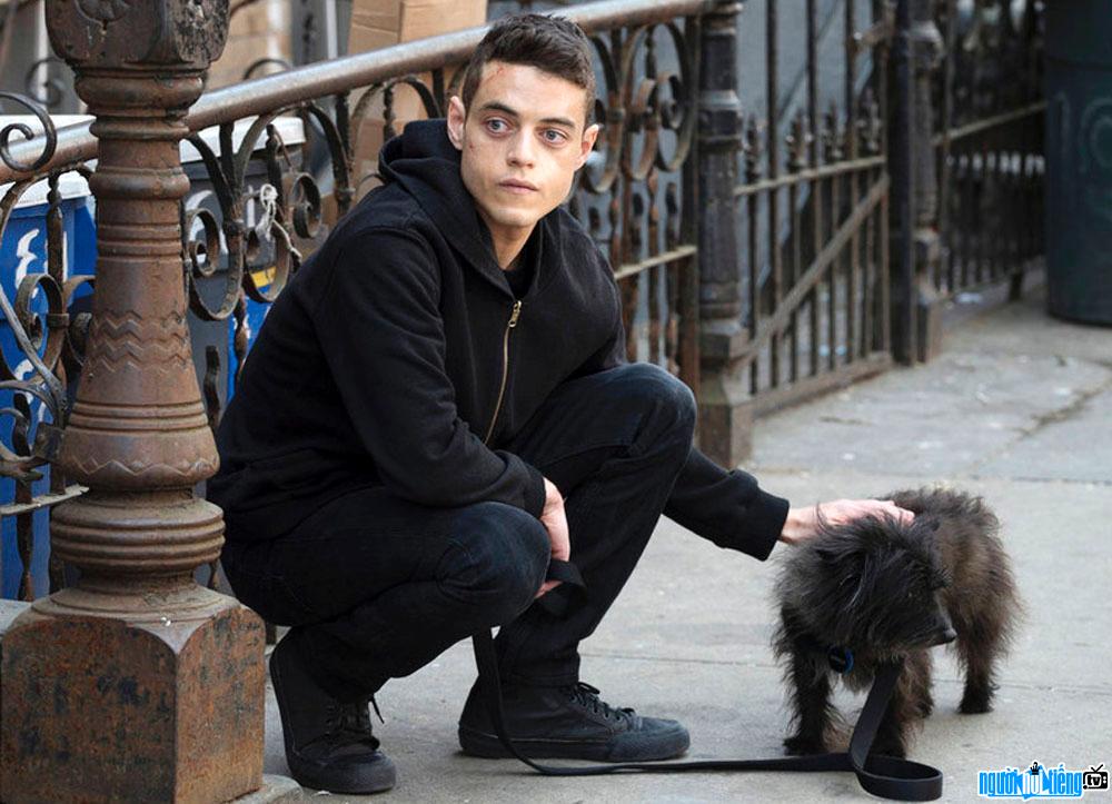 A photo of actor Rami Malek and his pet dog