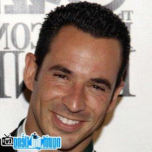 A portrait image of car racer Helio Castroneves