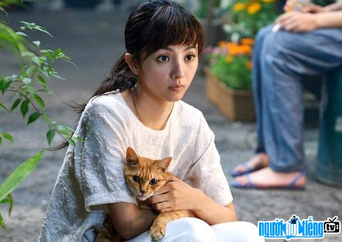 Actress Hikari Mitsushima posing with a cat