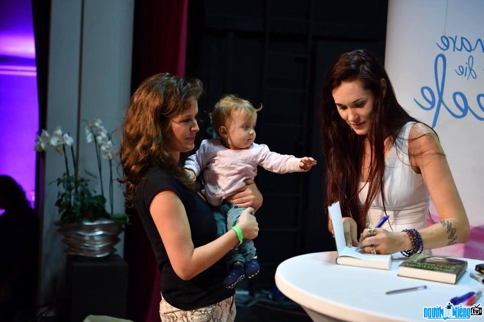Photo of Youtube Star Teal Swan giving autographs to fans