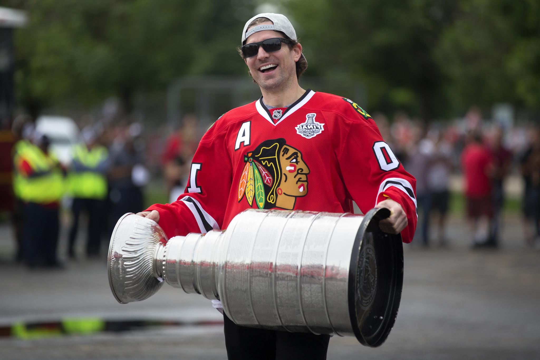 Athlete Patrick Sharp smiling with a gold cup
