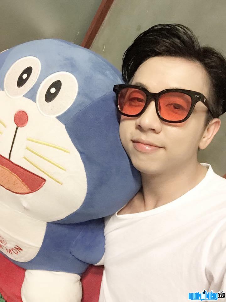  Ly Tuan Kiet posing with Doraemon plushies