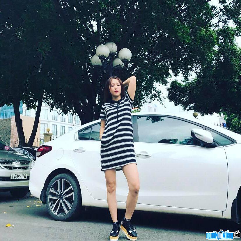 A photo of actress Suri Kim posing in a car